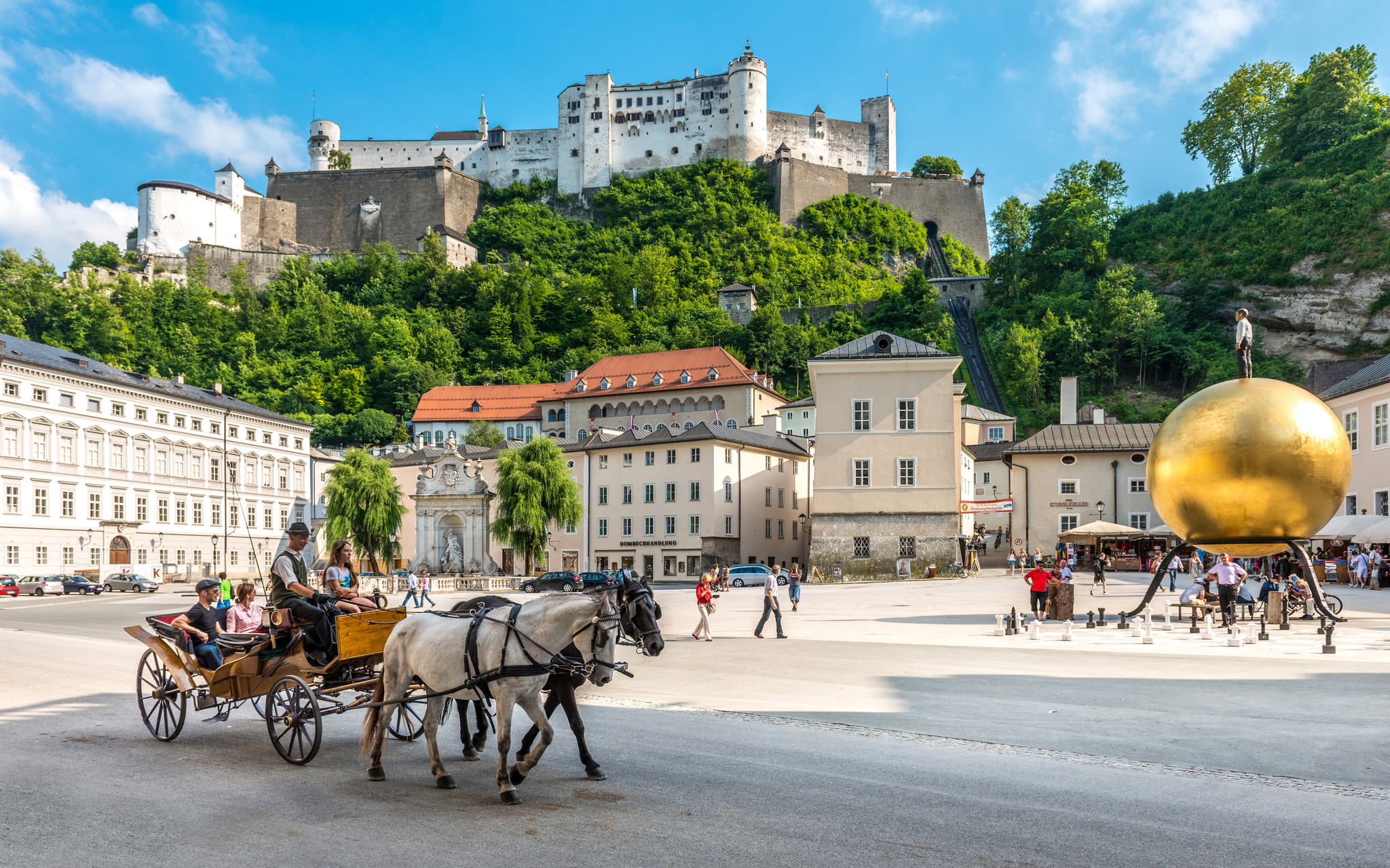 Kapitelplatz in Salzburg with Hohensalzburg Fortress and the golden Sphaera sculpture
